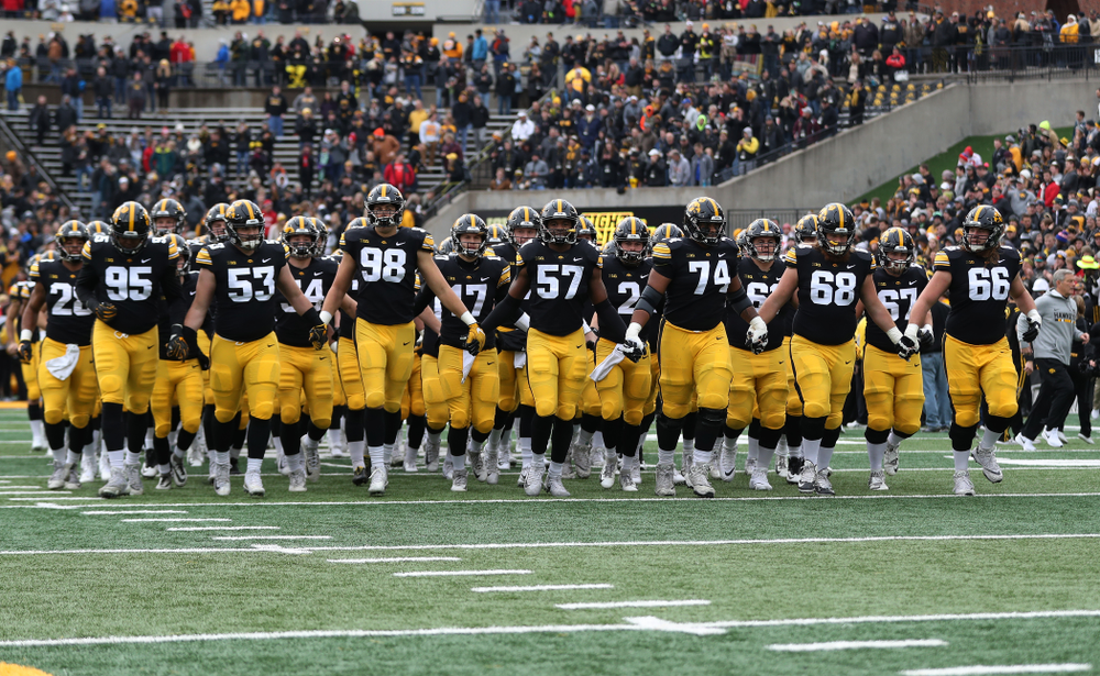 The Iowa Hawkeyes swarm onto the field before their game against the Nebraska Cornhuskers Friday, November 23, 2018 at Kinnick Stadium. (Brian Ray/hawkeyesports.com)