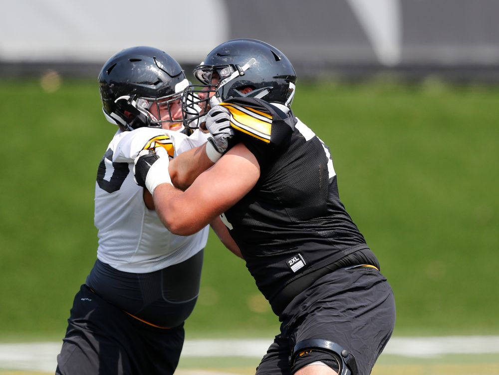 Iowa Hawkeyes offensive lineman Dalton Ferguson (76) and defensive end Sam Brincks (90) during fall camp practice No. 9 Friday, August 10, 2018 at the Kenyon Practice Facility. (Brian Ray/hawkeyesports.com)