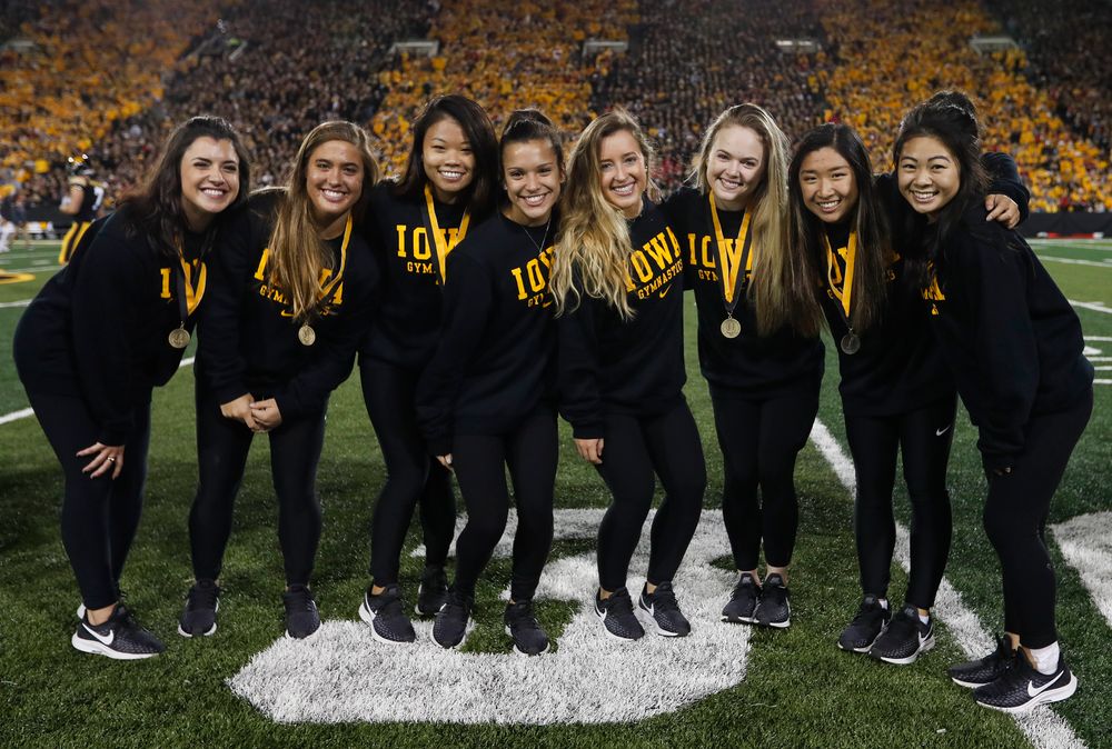 Members of the Iowa women's gymnastics team are recognized by the Presidential Committee on Athletics at halftime during a game against Wisconsin on September 22, 2018. (Tork Mason/hawkeyesports.com)