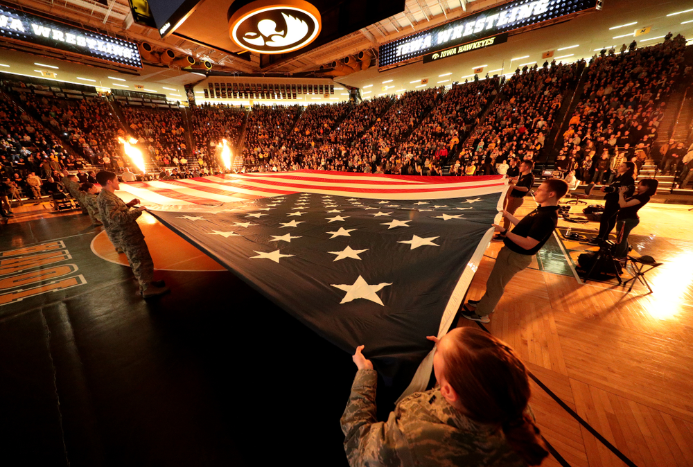 Members of the military spread out a large flag during the National Anthem before the Iowa Hawkeyes meet against Minnesota Saturday, February 15, 2020 at Carver-Hawkeye Arena. (Brian Ray/hawkeyesports.com)