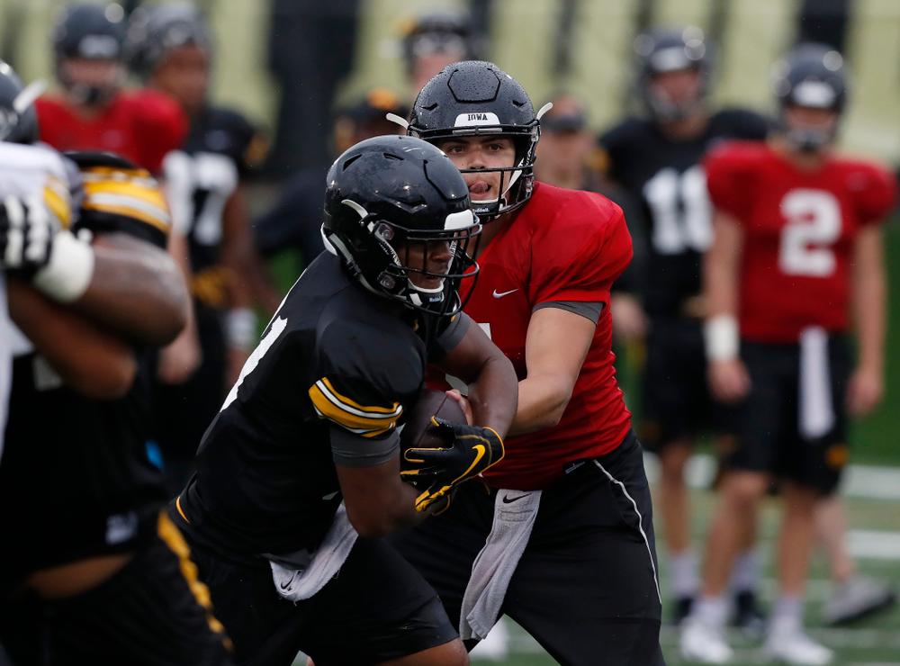 quarterback Nathan Stanley (4) and defensive back Josh Turner (4) during camp practice No. 15 Monday, August 20, 2018 at the Hansen Football Performance Center. (Brian Ray/hawkeyesports.com)