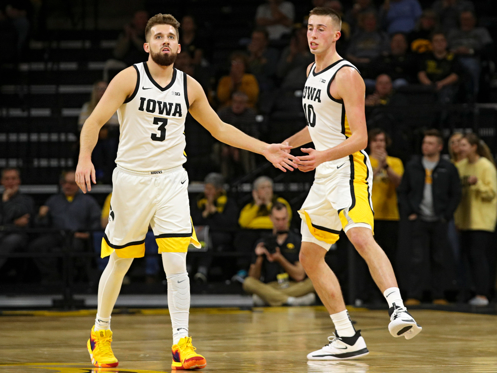 Iowa Hawkeyes guard Jordan Bohannon (3) slaps hands with guard Joe Wieskamp (10) as they run back on defense after a score during the first half of their game at Carver-Hawkeye Arena in Iowa City on Friday, Nov 8, 2019. (Stephen Mally/hawkeyesports.com)