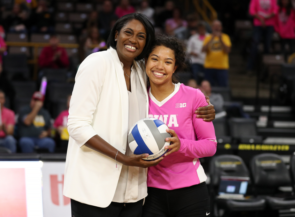 Iowa Hawkeyes head coach Vicki Brown presents setter Brie Orr (7) a ceremonial ball for her 300th assist before their game against the Michigan Wolverines Friday, October 11, 2019 at Carver-Hawkeye Arena.(Brian Ray/hawkeyesports.com)