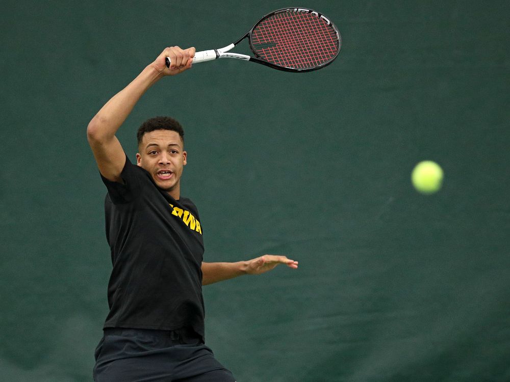 Iowa’s Oliver Okonkwo returns a shot during their match at the Hawkeye Tennis and Recreation Complex in Iowa City on Thursday, January 16, 2020. (Stephen Mally/hawkeyesports.com)