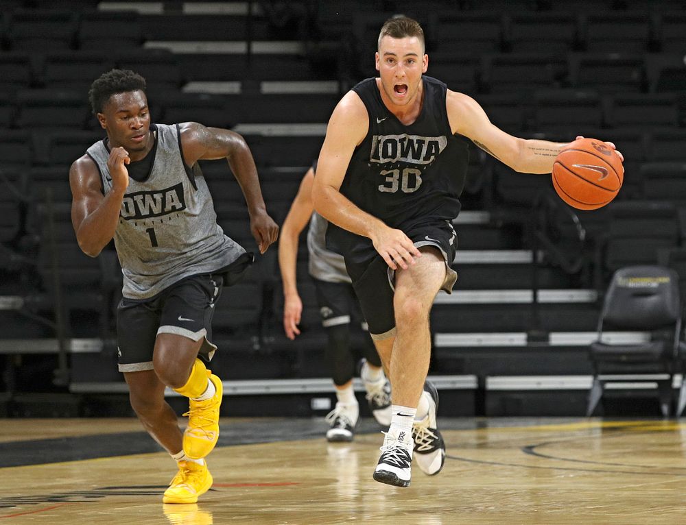 Iowa Hawkeyes guard Connor McCaffery (30) pushes the ball down the court as guard Joe Toussaint (1) gives chase during practice at Carver-Hawkeye Arena in Iowa City on Monday, Sep 30, 2019. (Stephen Mally/hawkeyesports.com)