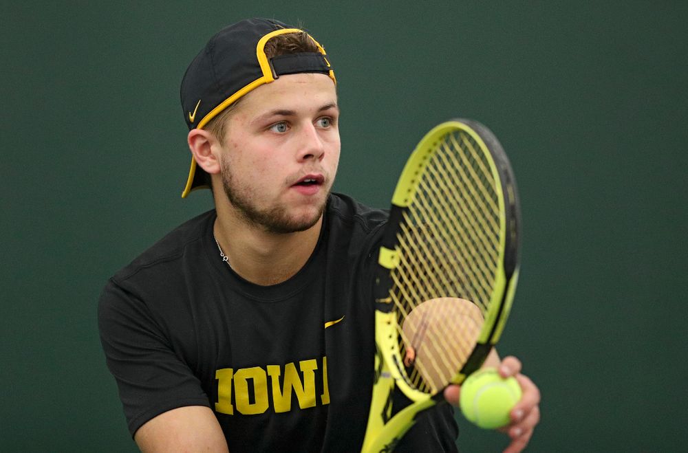 Iowa’s Will Davies serves during his match against Marquette at the Hawkeye Tennis and Recreation Complex in Iowa City on Saturday, January 25, 2020. (Stephen Mally/hawkeyesports.com)