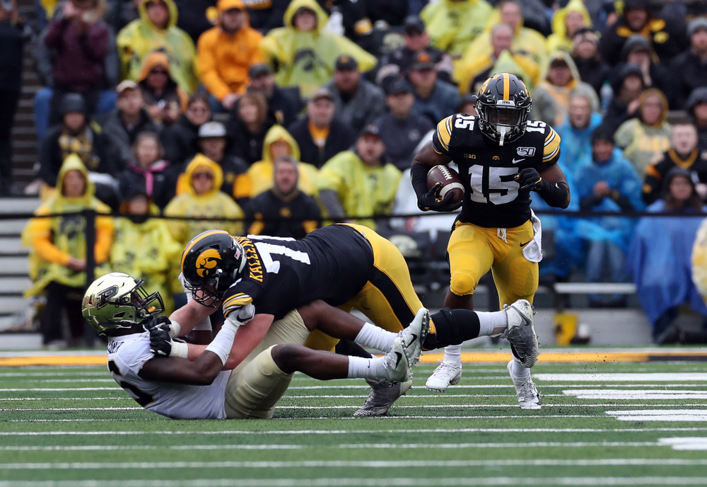 Iowa Hawkeyes running back Tyler Goodson (15) and offensive lineman Mark Kallenberger (71) against the Purdue Boilermakers Saturday, October 19, 2019 at Kinnick Stadium. (Brian Ray/hawkeyesports.com)