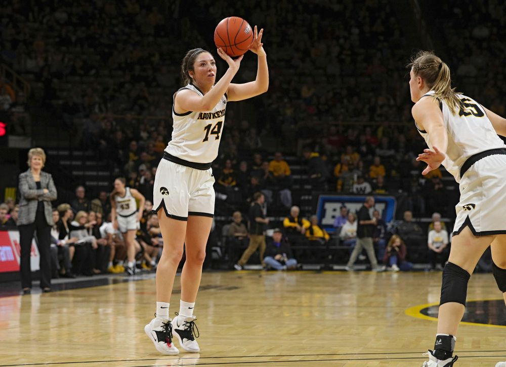 Iowa Hawkeyes guard Mckenna Warnock (14) makes a 3-pointer during the second quarter of their game at Carver-Hawkeye Arena in Iowa City on Sunday, January 26, 2020. (Stephen Mally/hawkeyesports.com)