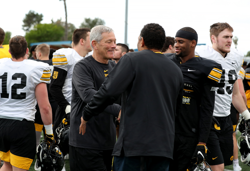Iowa Hawkeyes head coach Kirk Ferentz shakes hands with former Hawkeye Quinn Early following Holiday Bowl Practice No. 3 Tuesday, December 24, 2019 at San Diego Mesa College. (Brian Ray/hawkeyesports.com)