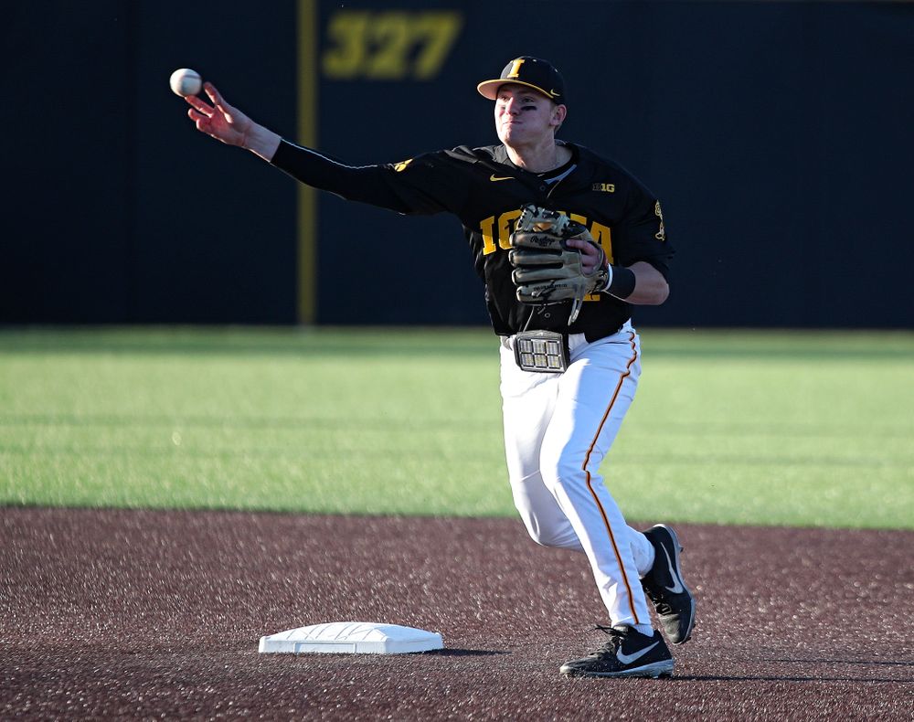 Iowa infielder Brendan Sher (2) throws to first to complete a double play during the third inning of their game at Duane Banks Field in Iowa City on Tuesday, March 3, 2020. (Stephen Mally/hawkeyesports.com)
