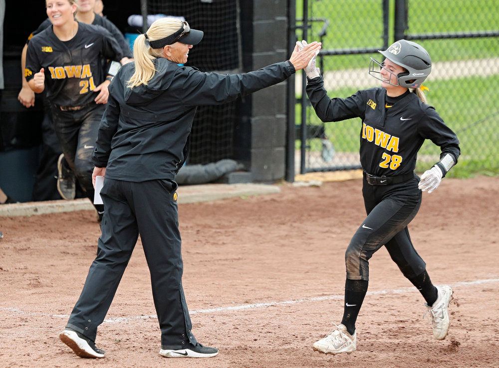 Iowa’s Taylor Ryan (28) gets a high-five from head coach Renee Gillispie as she rounds the bases after DoniRae Mayhew’s (not pictured) home run during the sixth inning of their game against Iowa Softball vs Indian Hills Community College at Pearl Field in Iowa City on Sunday, Oct 6, 2019. (Stephen Mally/hawkeyesports.com)