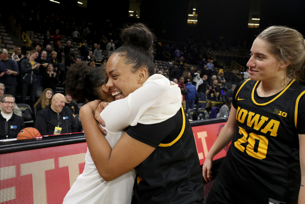 Iowa Hawkeyes guard Alexis Sevillian (5) hugs former Hawkeye and Clemson graduate assistant Tania Davis following their game Wednesday, December 4, 2019 at Carver-Hawkeye Arena. (Brian Ray/hawkeyesports.com)