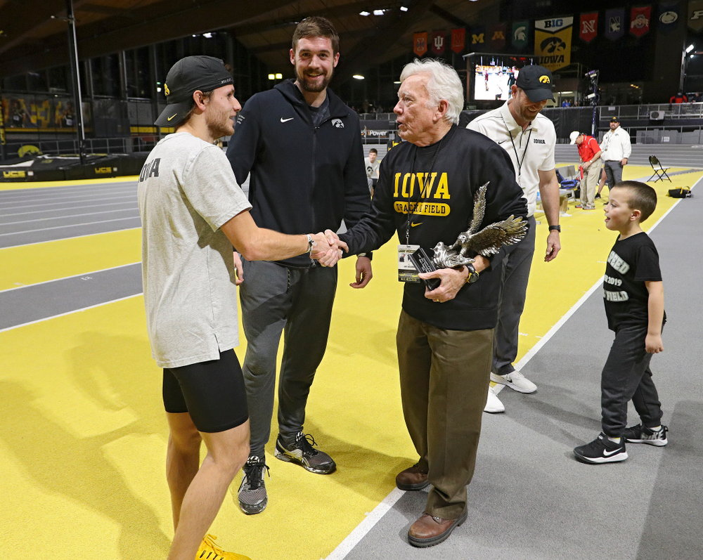 Larry Wieczorek (right) presents the men’s team award to Iowa’s Tysen VanDraska (left) and Nolan Teubel during the Larry Wieczorek Invitational at the Recreation Building in Iowa City on Saturday, January 18, 2020. (Stephen Mally/hawkeyesports.com)
