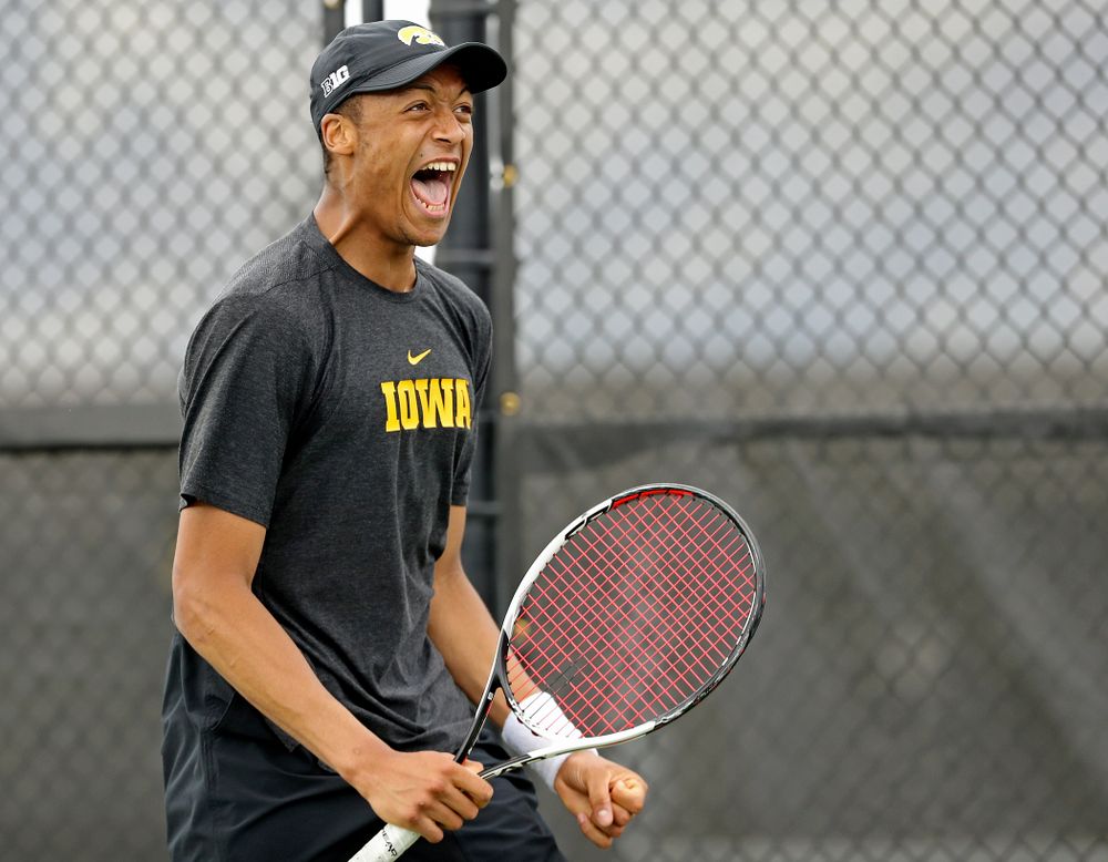 Iowa's Oliver Okonkwo celebrates as he competes during a match against Ohio State at the Hawkeye Tennis and Recreation Complex in Iowa City on Sunday, Apr. 7, 2019. (Stephen Mally/hawkeyesports.com)