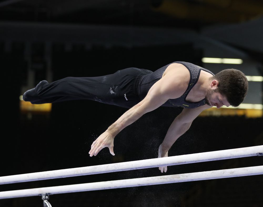 Iowa's Rogelio Vazquez competes on the parallel bars against the Ohio State Buckeyes Saturday, March 16, 2019 at Carver-Hawkeye Arena. (Brian Ray/hawkeyesports.com)
