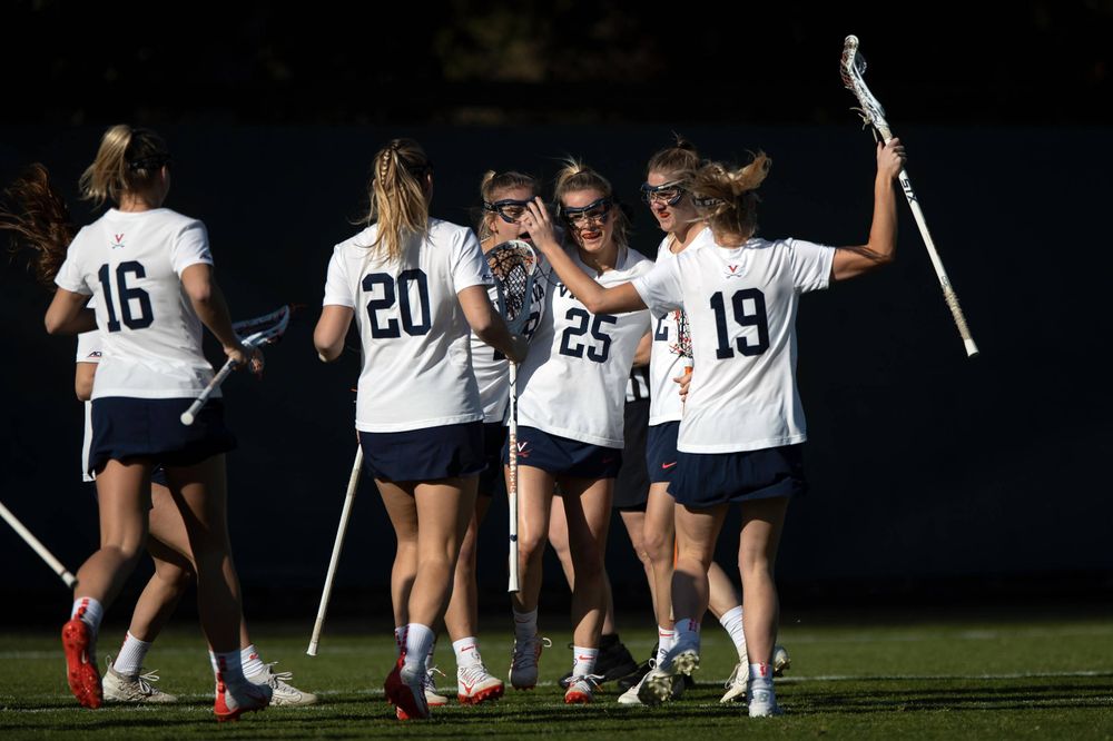STANFORD, California - FEBRUARY 14: Virginia Cavaliers midfield Courtlynne Caskin (25) is congratulated by teammates after scoring a goal against the Stanford Cardinal during the first half at Cagan Stadium on February 14, 2020 in Stanford, California. The Virginia Cavaliers defeated the Stanford Cardinal 12-11. (Photo by Jason O. Watson)