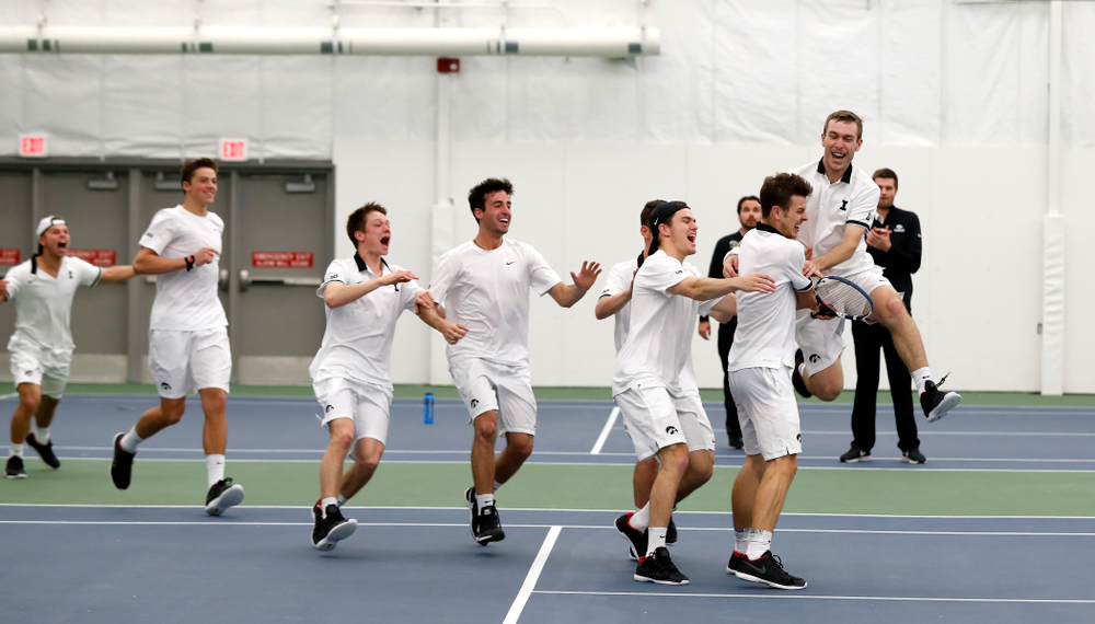Iowa's Piotr Smietana celebrates with his teammates after clinching the match against Purdue Sunday, April 15, 2018 at the Hawkeye Tennis an