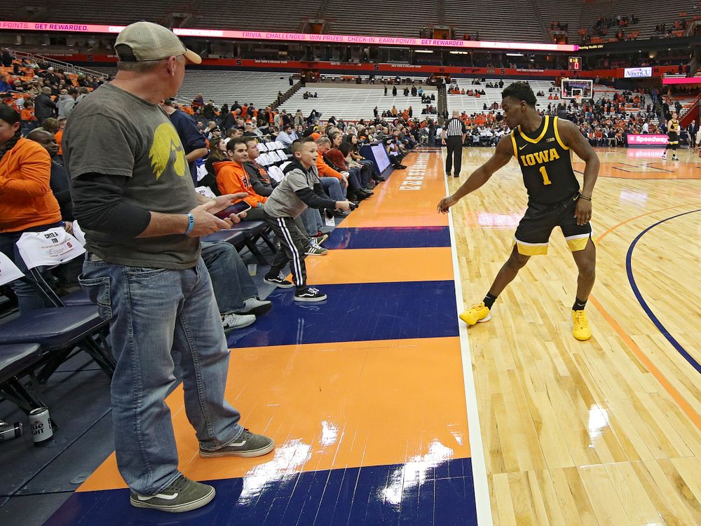 Iowa Hawkeyes guard Joe Toussaint (1) gives his sleeve to a young fan after winning their ACC/Big Ten Challenge game at the Carrier Dome in Syracuse, N.Y. on Tuesday, Dec 3, 2019. (Stephen Mally/hawkeyesports.com)