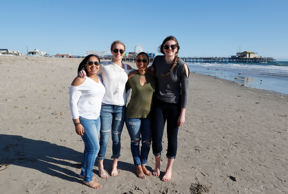 Iowa Hawkeyes guard Tania Davis (11), guard Makenzie Meyer (3), forward Megan Gustafson (10), and guard Alexis Sevillian (5) as they explore the beach Thursday, March 15, 2018 in Santa Monica. (Brian Ray/hawkeyesports.com)