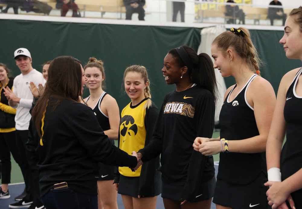 Academic Student Services Associate Director Kara Park congratulates Adorabol Huckleby for earning a 3.0 GPA or better during the fall semester before their match against the Penn State Nittany Lions Sunday, February 24, 2019 at the Hawkeye Tennis and Recreation Complex. (Brian Ray/hawkeyesports.com)