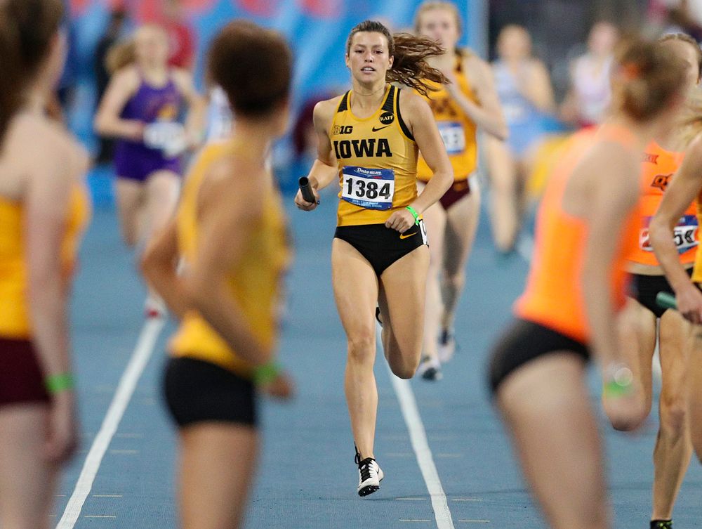 Iowa's Taylor Arco prepares to hand off the baton to Tia Saunders runs the women's 3200 meter relay event during the second day of the Drake Relays at Drake Stadium in Des Moines on Friday, Apr. 26, 2019. (Stephen Mally/hawkeyesports.com)