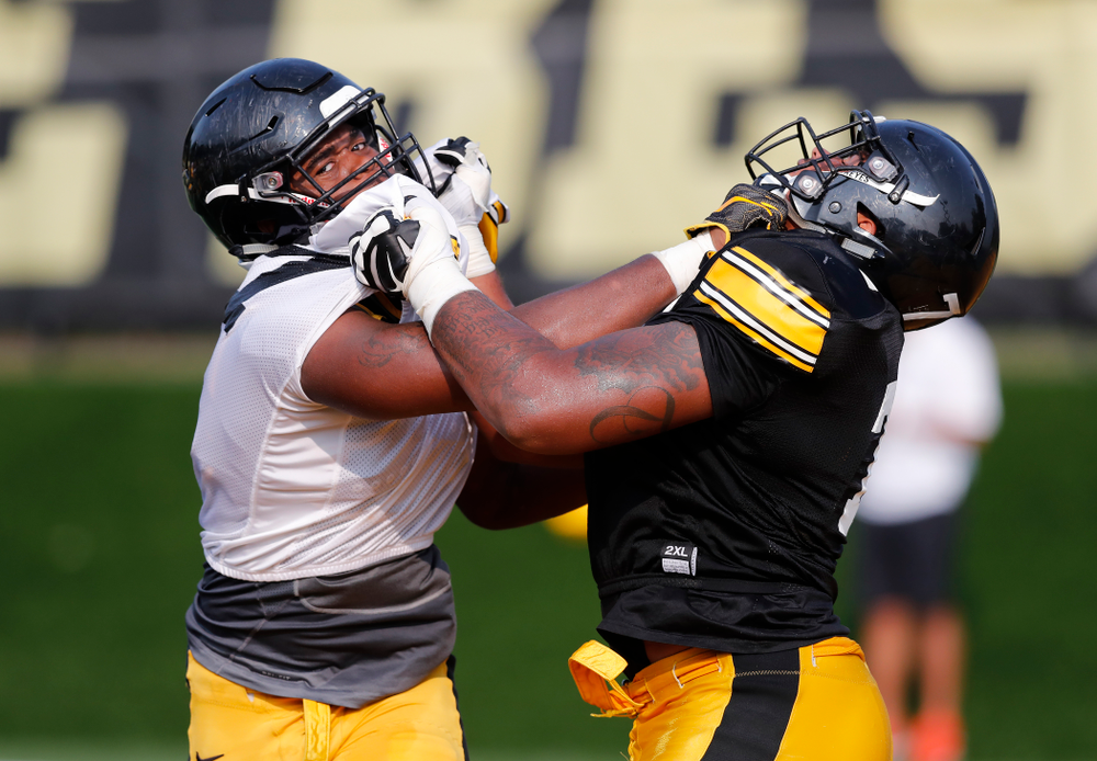 Iowa Hawkeyes defensive end Chauncey Golston (57) and offensive lineman Tristan Wirfs (74) during camp practice No. 16 Tuesday, August 21, 2018 at the Hansen Football Performance Center. (Brian Ray/hawkeyesports.com)
