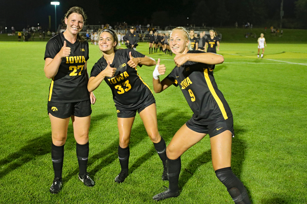 Iowa forward Samantha Tawharu (27), defender Riley Burns (33), and defender Samantha Cary (9) celebrate after their match against Western Michigan at the Iowa Soccer Complex in Iowa City on Thursday, Aug 22, 2019. (Stephen Mally/hawkeyesports.com)