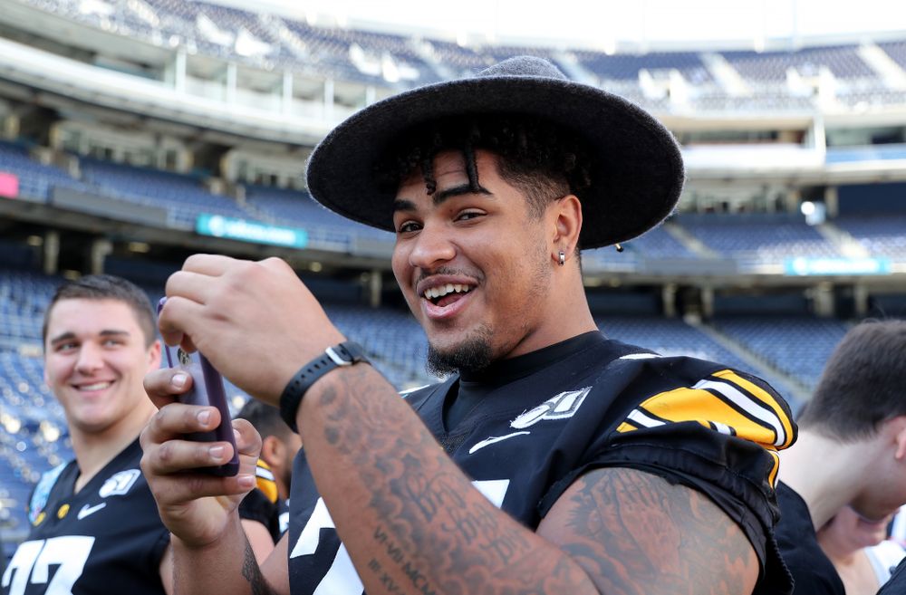 Iowa Hawkeyes offensive lineman Tristan Wirfs (74) following the team photo Wednesday, December 25, 2019 at SDCCU Stadium in San Diego. (Brian Ray/hawkeyesports.com)