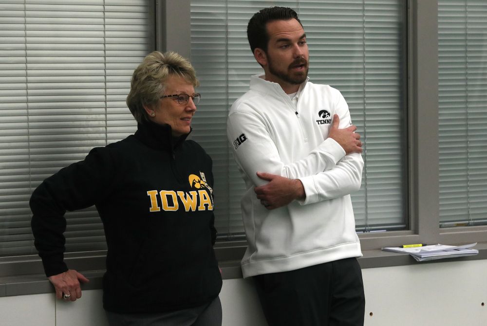 Iowa Hawkeyes Head Coach Ross Wilson talks with Deputy Athletics Director Barbara Burke before their match against the Butler Bulldogs Sunday, January 27, 2019 at the Hawkeye Tennis and Recreation Complex. (Brian Ray/hawkeyesports.com)
