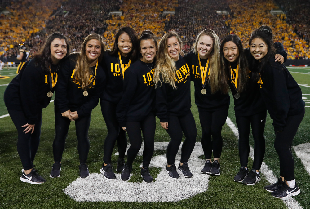 Members of the Iowa women's gymnastics team are recognized by the Presidential Committee on Athletics at halftime during a game against Wisconsin on September 22, 2018. (Tork Mason/hawkeyesports.com)