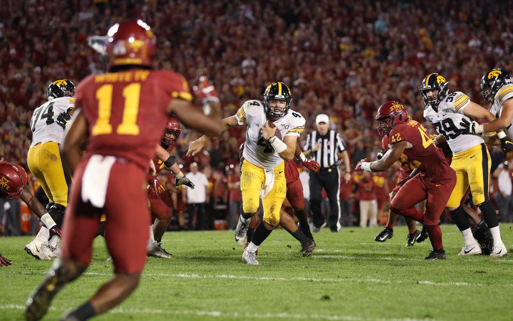 Iowa Hawkeyes quarterback Nate Stanley (4) picks up a first down against the Iowa State Cyclones Saturday, September 14, 2019 in Ames, Iowa. (Brian Ray/hawkeyesports.com)