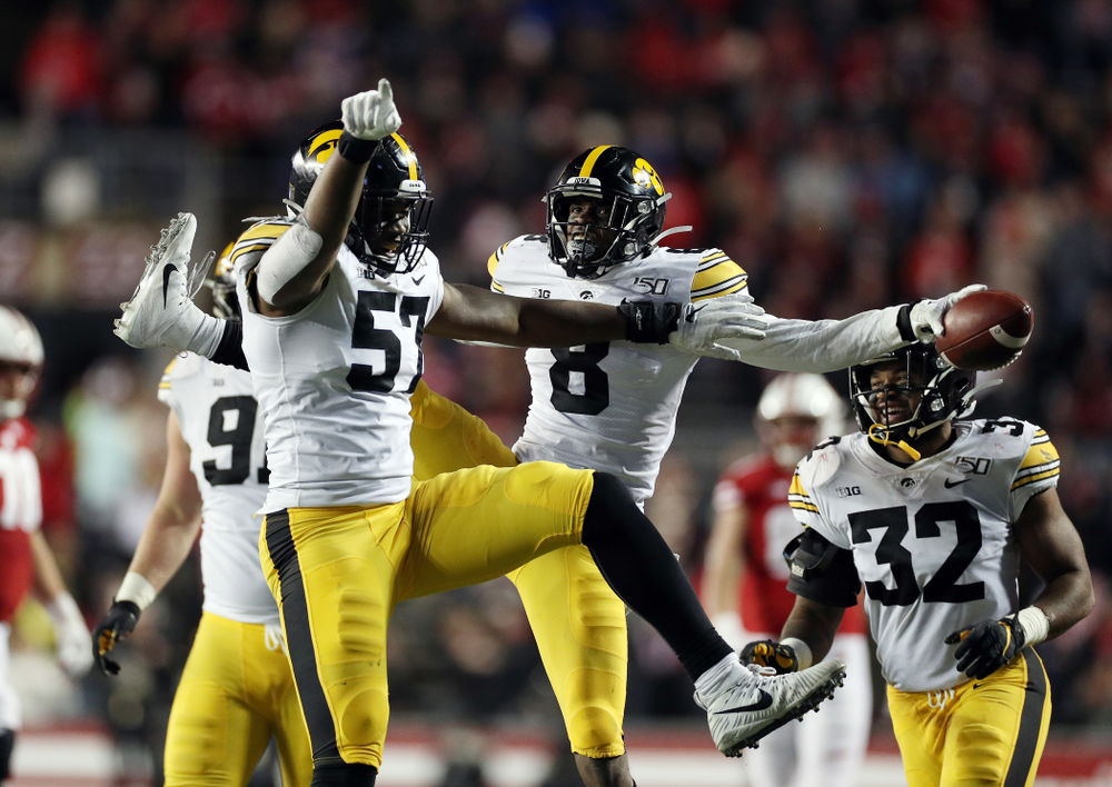 Iowa Hawkeyes defensive end Chauncey Golston (57) and defensive back Matt Hankins (8) against the Wisconsin Badgers Saturday, November 9, 2019 at Camp Randall Stadium in Madison, Wisc. (Brian Ray/hawkeyesports.com)