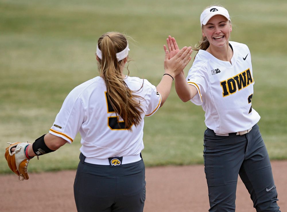 Iowa Hawkeyes Sydney Owens (5) gets a high-five from Aralee Bogar (2) as she takes the field before their Big Ten Conference softball game at Pearl Field in Iowa City on Friday, Mar. 29, 2019. (Stephen Mally/hawkeyesports.com)