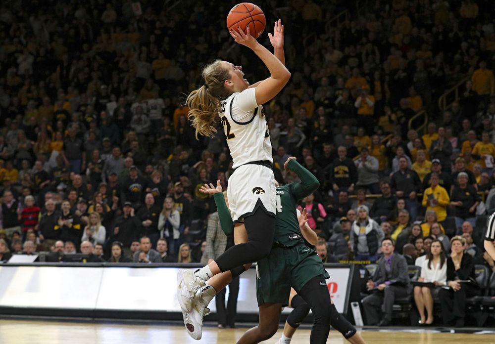 Iowa Hawkeyes guard Kathleen Doyle (22) scores a basket while being fouled during the fourth quarter of their game at Carver-Hawkeye Arena in Iowa City on Sunday, January 26, 2020. (Stephen Mally/hawkeyesports.com)