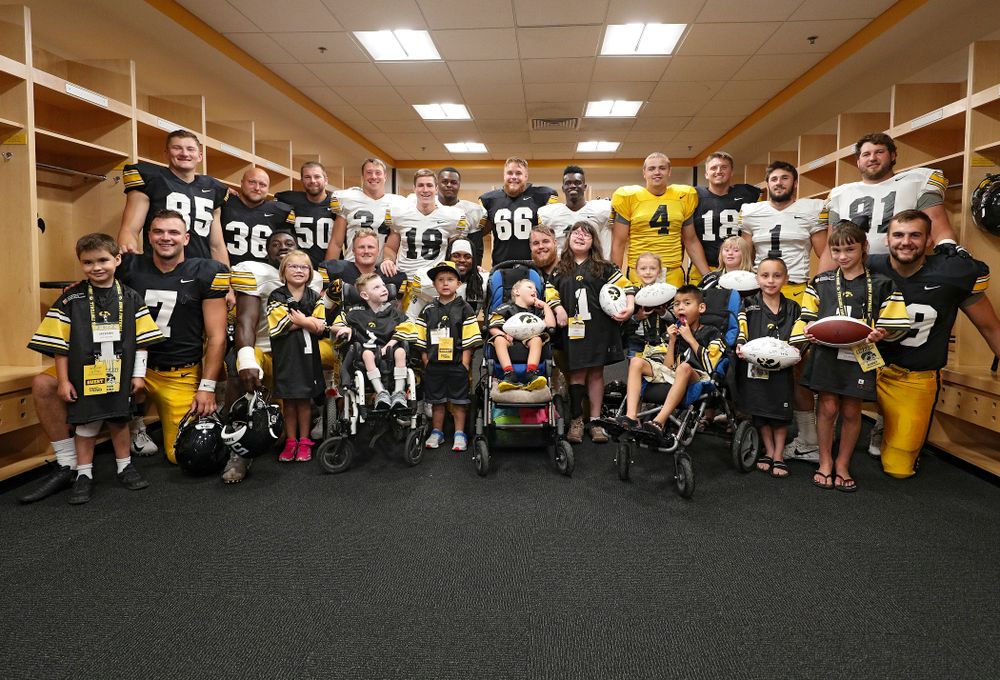 The 2019 Kid Captains with Iowa players during Kids Day at Kinnick Stadium in Iowa City on Saturday, Aug 10, 2019. (Stephen Mally/hawkeyesports.com)