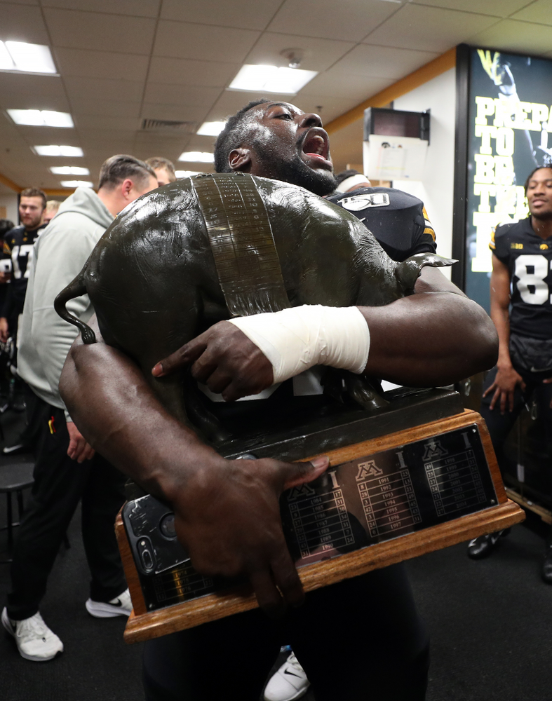 Iowa Hawkeyes linebacker Amani Jones (52) holds the Floyd of Rosedale Trophy following their win against the Minnesota Golden Gophers Saturday, November 16, 2019 at Kinnick Stadium. (Brian Ray/hawkeyesports.com)
