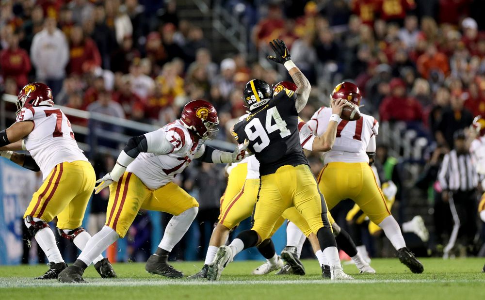 Iowa Hawkeyes defensive end A.J. Epenesa (94) causes a fumble against USC in the Holiday Bowl Friday, December 27, 2019 at San Diego Community Credit Union Stadium. (Brian Ray/hawkeyesports.com)