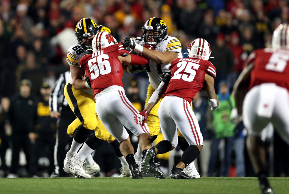 Iowa Hawkeyes offensive lineman Landan Paulsen (68) and offensive lineman Alaric Jackson (77) against the Wisconsin Badgers Saturday, November 9, 2019 at Camp Randall Stadium in Madison, Wisc. (Brian Ray/hawkeyesports.com)
