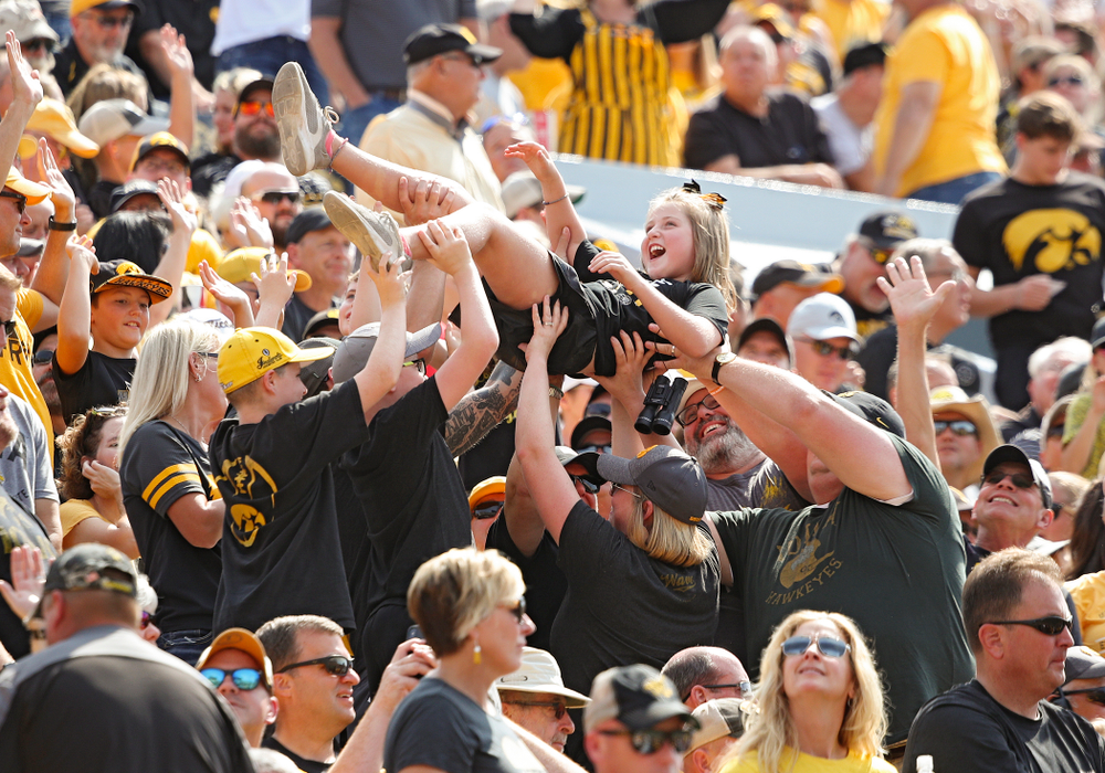 A young fan is lifted in the air during the second quarter of their Big Ten Conference football game at Kinnick Stadium in Iowa City on Saturday, Sep 7, 2019. (Stephen Mally/hawkeyesports.com)