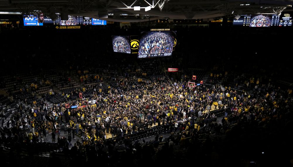 Fans storm the court after Iowa Hawkeyes defeated the Michigan Wolverines Friday, February 1, 2019 at Carver-Hawkeye Arena. (Brian Ray/hawkeyesports.com)