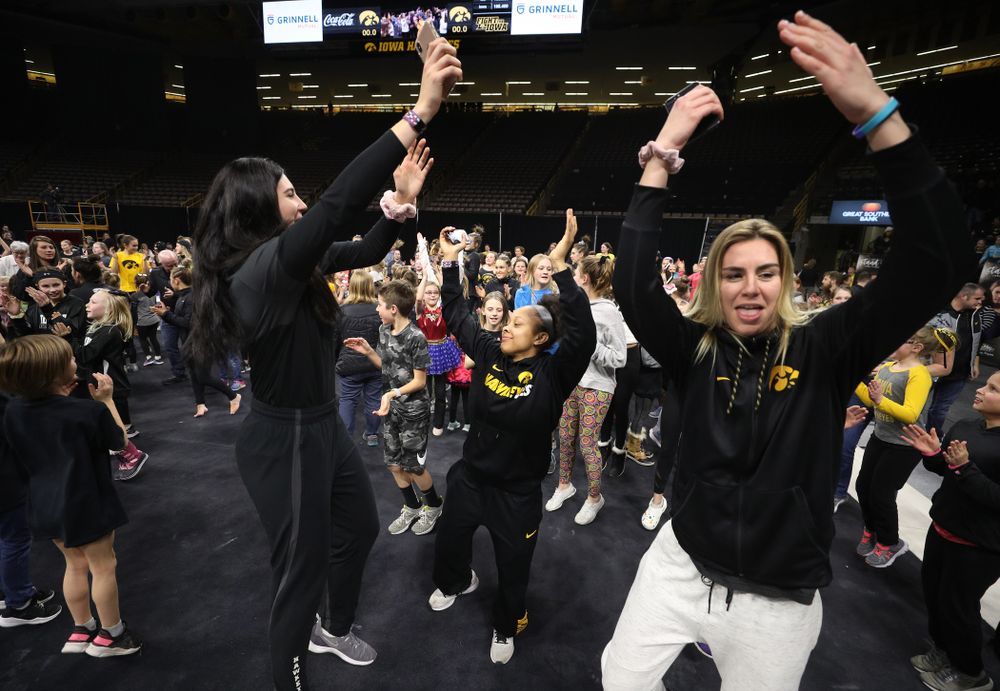 Iowa Women's Basketball seniors Megan Gustafson, Tania Davis, and forward Hannah Stewart (21) present the awards and dance the Cha Cha Slide following the Gymhawks meet against Illinois Saturday, February 16, 2019 at Carver-Hawkeye Arena. (Brian Ray/hawkeyesports.com)