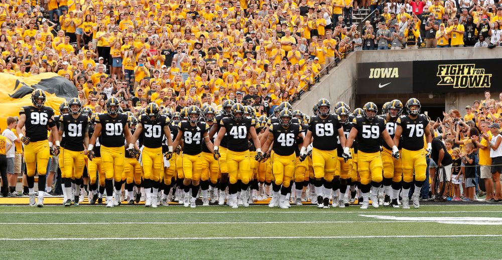 The Iowa Hawkeyes swarm onto the field against the Northern Illinois Huskies Saturday, September 1, 2018 at Kinnick Stadium. (Brian Ray/hawkeyesports.com)