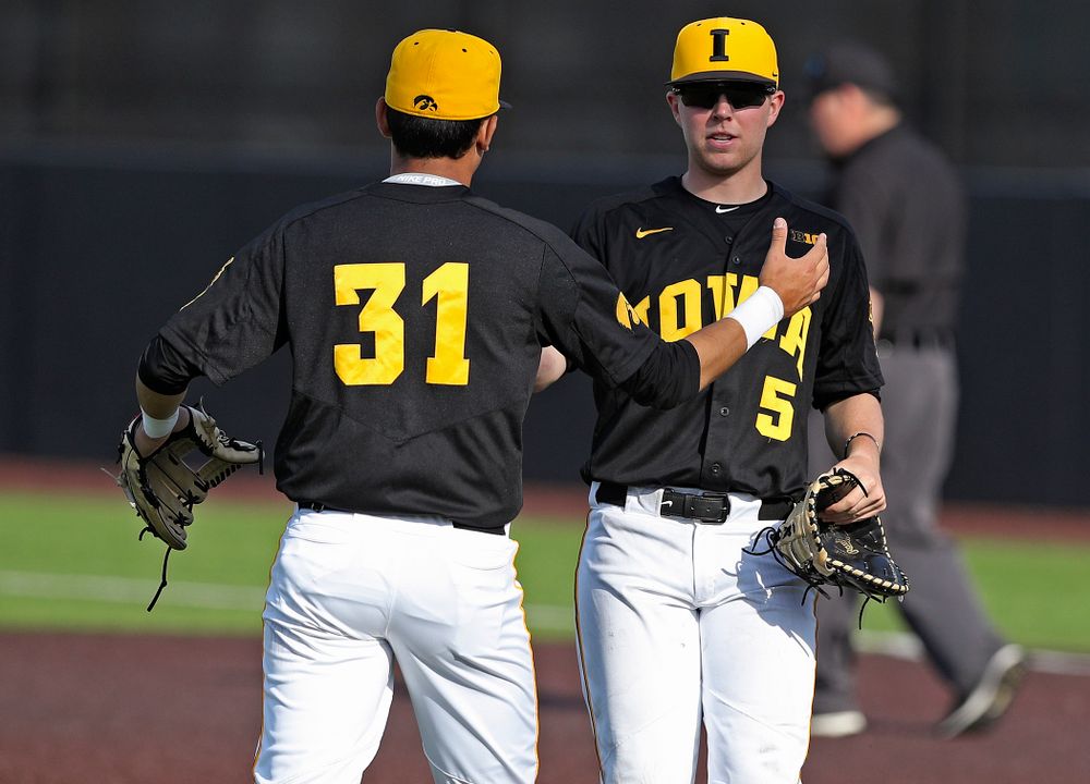 Iowa Hawkeyes third baseman Matthew Sosa (31) and first baseman Zeb Adreon (5) celebrate after winning their game against Rutgers at Duane Banks Field in Iowa City on Saturday, Apr. 6, 2019. (Stephen Mally/hawkeyesports.com)