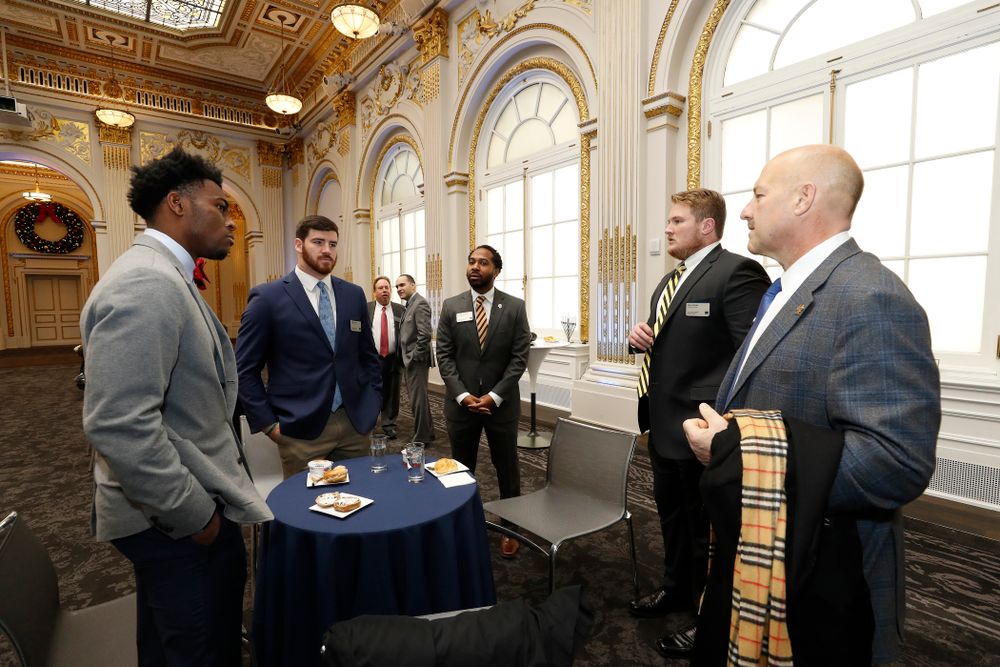 Iowa Hawkeyes linebacker Josey Jewell (43), defensive back Joshua Jackson (15), offensive lineman Sean Welsh (79) and head coach Kirk Ferentz ring the opening bell at the New York Stock Exchange Tuesday, December 26, 2017 in New York. (Brian Ray/hawkeyesports.com)