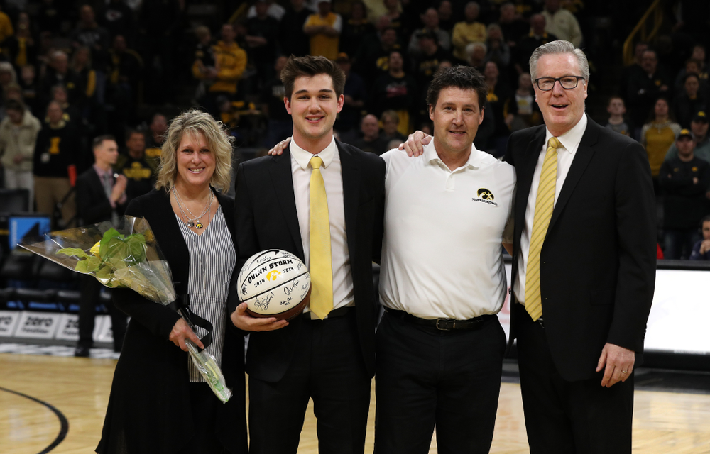 Senior Manager Quinn Storm stands with Iowa Hawkeyes head coach Fran McCaffery and his family during senior day activities before their game against the Rutgers Scarlet Knights Saturday, March 2, 2019 at Carver-Hawkeye Arena. (Brian Ray/hawkeyesports.com)