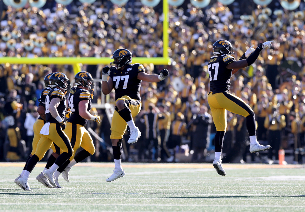 Iowa Hawkeyes offensive lineman Alaric Jackson (77) and defensive end Chauncey Golston (57) against the Illinois Fighting Illini Saturday, November 23, 2019 at Kinnick Stadium. (Brian Ray/hawkeyesports.com)