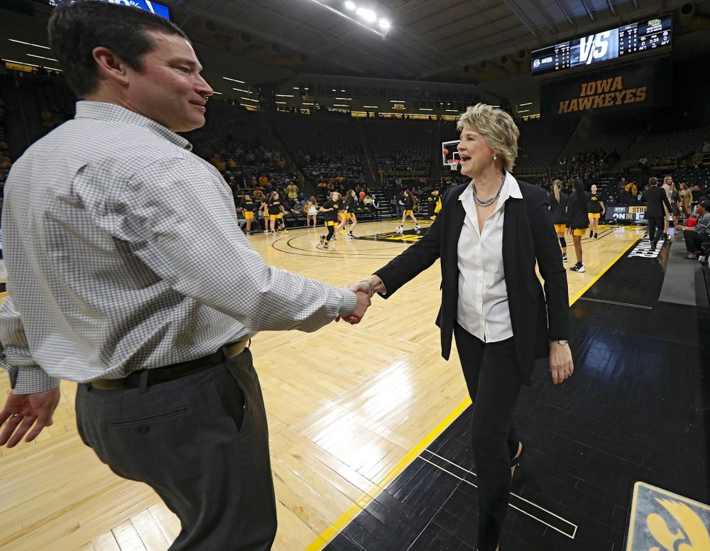 Ohio State Buckeyes head coach Kevin McGuff (from left) shakes hands with Iowa Hawkeyes head coach Lisa Bluder before their game at Carver-Hawkeye Arena in Iowa City on Thursday, January 23, 2020. (Stephen Mally/hawkeyesports.com)