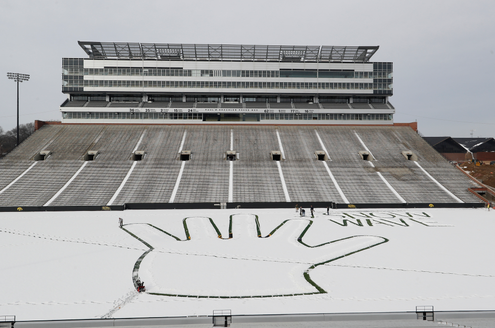 Members of the Iowa Athletics Turf Management staff create the #SnowWave for kids in the Stead Family Children's Hospital Thursday, February