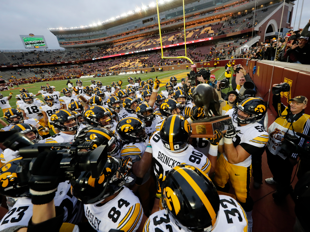 The Iowa Hawkeyes celebrate with the Floyd of Rosedale trophy following their win over the Minnesota Golden Gophers Saturday, October 6, 2018 at TCF Bank Stadium. (Brian Ray/hawkeyesports.com)