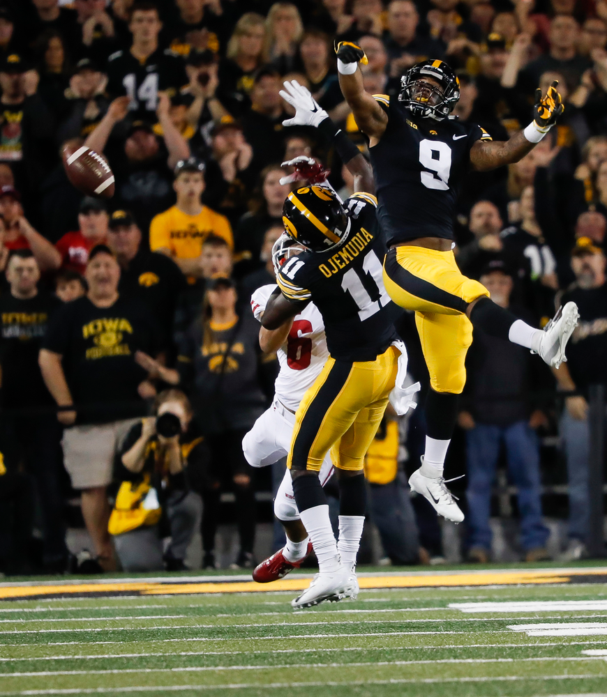 Iowa Hawkeyes defensive back Geno Stone (9) breaks up a pass during a game against Wisconsin at Kinnick Stadium on September 22, 2018. (Tork Mason/hawkeyesports.com)